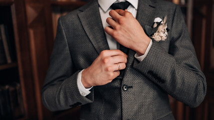 Groom fixing his tie, groom getting ready, bohemian wedding.