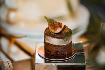 A layered dessert with chocolate, nuts and cream cheese , close up. Festive baking.