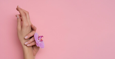 Natural manicure on pink background.