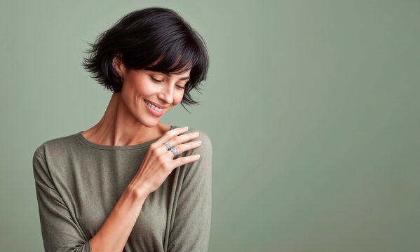 portrait of a woman, Portrait of a beautiful young woman with short hair against green background. 