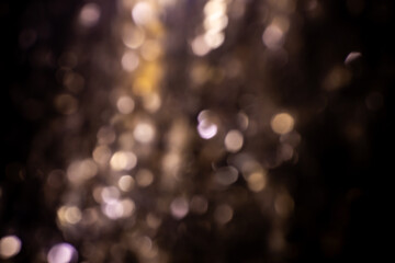 abstract golden lights on black background. blurred party lights.