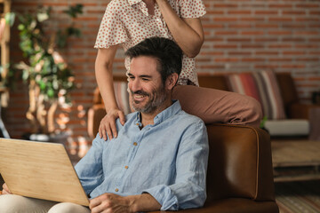 portrait mature man sitting in the armchair checking his savings and marital assets happy to earn...