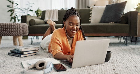 Laptop, smile and woman typing on the floor in the living room of modern apartment for research....