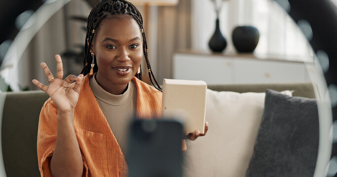 Wave, Live Streaming And Happy Black Woman With Box Or Product In Home Living Room. Hello, Influencer And Person With Package, Record Video On Social Media And Content Creation, Ring Light And Phone