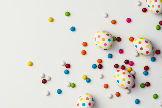 Spotty painted colourful easter eggs  and sugar coated chocolate beans