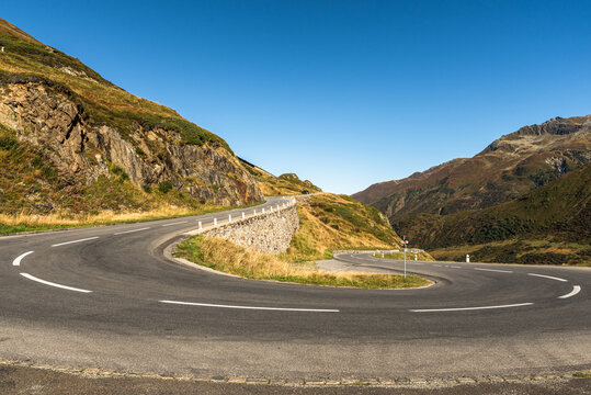 Hairpin bend on empty road at Oberalp Pass, Canton of Graubuenden, Switzerland - Powered by Adobe