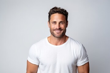 Portrait of handsome man in white t-shirt on grey background