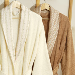 Bathrobe set - Hanger with clean bathrobe and towel on light wall bathrobe mockup