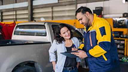 Customer women happy enjoy with mechanic worker car service check list in auto center workshop