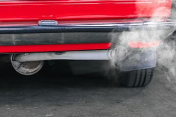 closeup old car rear exhaust pipe with smell smoke carbon monoxide bad air pollution lung disease