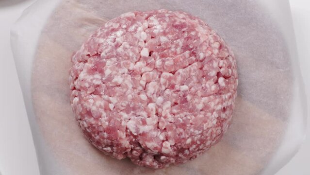 uncooked minced pork on wrapping paper top view 