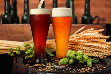 Beer. Still life with Vintage beer barrel and two glasses of dark and light beer. Fresh amber beer...