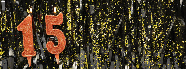 Burning red birthday candles on glitter tinsel background, number 15. Banner.