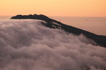 Foto op Canvas Sunrise in mountains with inversion phenomenon and low clouds lit by sun. Refugio Punta de Los Roques, National Park Caldera de Taburiente, La Palma, Canary Islands, Spain © Iwona