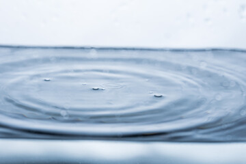 Captivating image of water ripples with floating bubbles, creating dynamic motion against a...