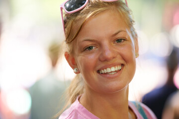 Woman, portrait and happy at festival in nature, excited and travel leisure for wellness in forest. Young person, happiness and face outdoor at carnival in bokeh, relax and summer holiday in europe