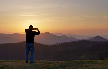 Sunset in Euskadi. Man photographing the sunset in the mountains of Euskadi.