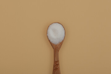 Pure GDL, white odorless crystalline powder in wooden spoon. Food additive E575 used as acidity...