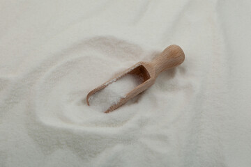 Pile of gluconolactone, close-up. Glucono Delta-Lactone, Pure GDL in wooden scoop. White powder,...