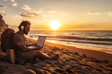 A man working on laptop at the beach