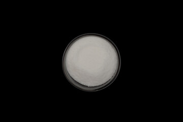 Gluconolactone, White powder, oxidized derivative of glucose. Food additive E575 in glass dish on...