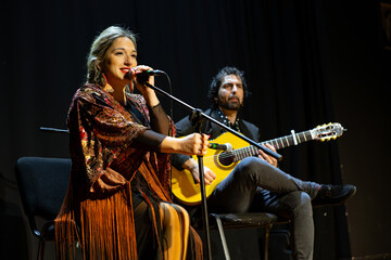 Obraz premium Flamenco performance with female singer and guitarist on stage, copy space.