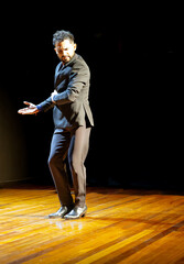 Male flamenco dancer in mid-performance, copy space.