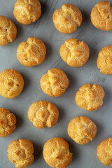 Homemade Mini Cream Puffs on a gray background, top view.