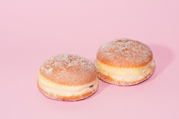 Traditional German Carnival Sweets  Berliner, Pfannkuchen or Krapfen in front of a colourful background