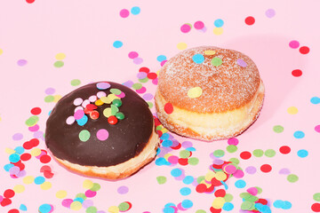 Traditional German Carnival Sweets  Berliner, Pfannkuchen or Krapfen in front of a colourful background