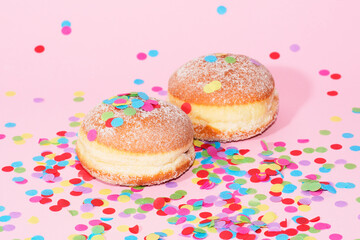 Traditional German Carnival Sweets  Berliner, Pfannkuchen or Krapfen in front of a colourful background