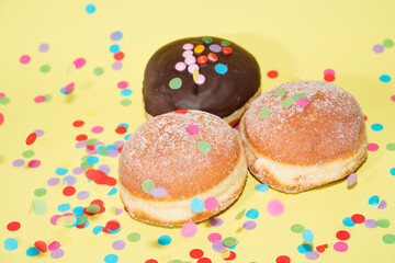 Traditional German Carnival Sweets  Berliner, Pfannkuchen or Krapfen in front of a colourful background