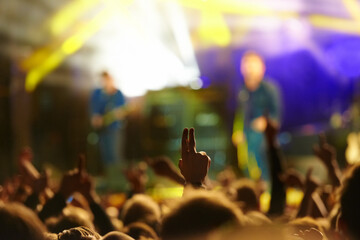 Concert, audience and hand or sign with band for music festival, night club and cheering with...
