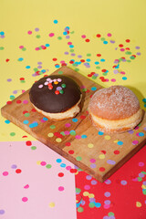 Traditional German Carnival Sweets  Berliner, Pfannkuchen or Krapfen in front of a colourful background