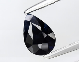 natural dark black sapphire gem on the background