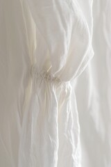 A close up of a white dress on a hanger. Suitable for fashion, clothing, and wardrobe concepts