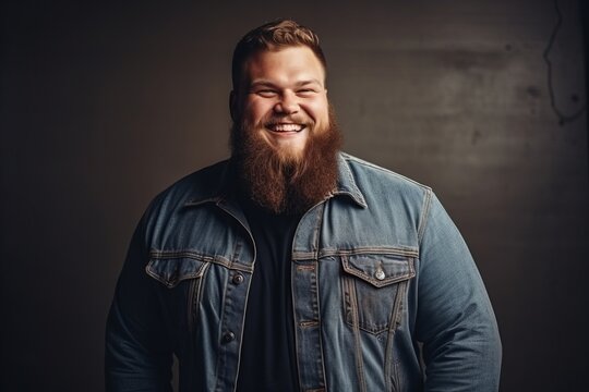 Portrait of a handsome bearded hipster man over dark background.