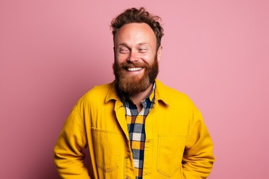 Portrait of a smiling hipster man over pink background. Looking at camera.