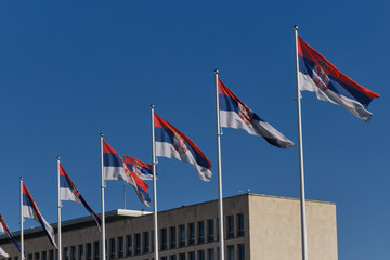 Palace of Serbia, Novi Beograd district. A lot of Flags of Serbia waiving in front of Palata Srbija. Office of various state administrations in Belgrade. - obrazy, fototapety, plakaty