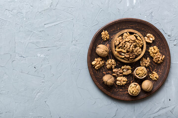 Fresh healthy walnuts in bowl on colored table background. Top view Healthy eating bertholletia concept. Super foods