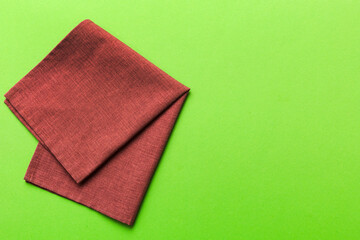 top view with red empty kitchen napkin isolated on table background. Folded cloth for mockup with copy space, Flat lay. Minimal style