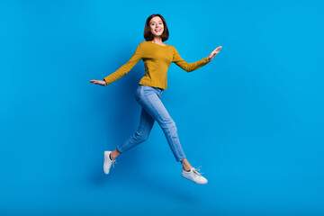 Fototapeta na wymiar Full length photo of excited sweet lady dressed shirt jumping high running fast empty space isolated blue color background