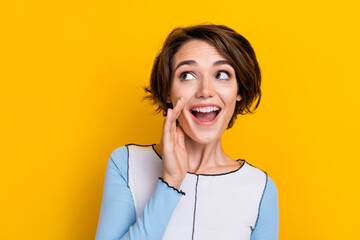 Photo of excited funky woman wear top arm mouth looking empty space isolated yellow color background