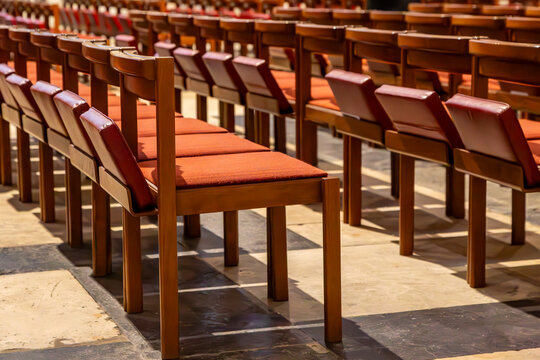 Chairs with kneelers in a church, ready for the congregation
