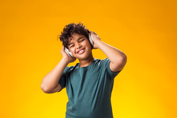 Smiling child boy with headphone listening to a music. Leisure and entertainment concept