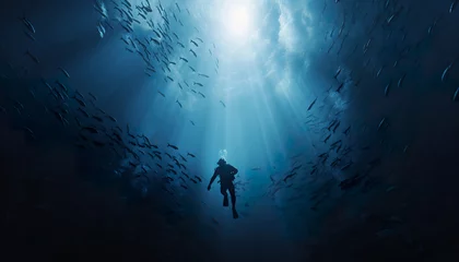 Fotobehang person scuba diver swimming underwater, man diving in deep blue sea or ocean © goami