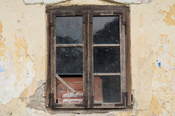 Croatia, October 20,2023 : Rustic style aged window at rural home wall.