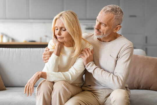 Loving supportive senior man husband comforting his upset wife - Powered by Adobe