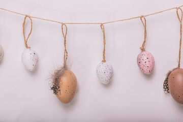 Easter decorations hanging on a string against a bright backdrop. Ideal for festive greeting cards...