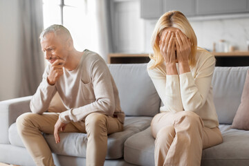 Mature blonde woman crying after quarrel with husband